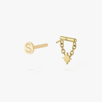 This is an image of a gold toned flatback stud which has a bar with chains from either side supporting a dangling twinkle star with a clear, round CZ center stone. 