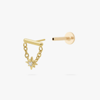 This is an image of a gold toned flatback stud which has a bar with chains from either side supporting a dangling twinkle star with a clear, round CZ center stone. 