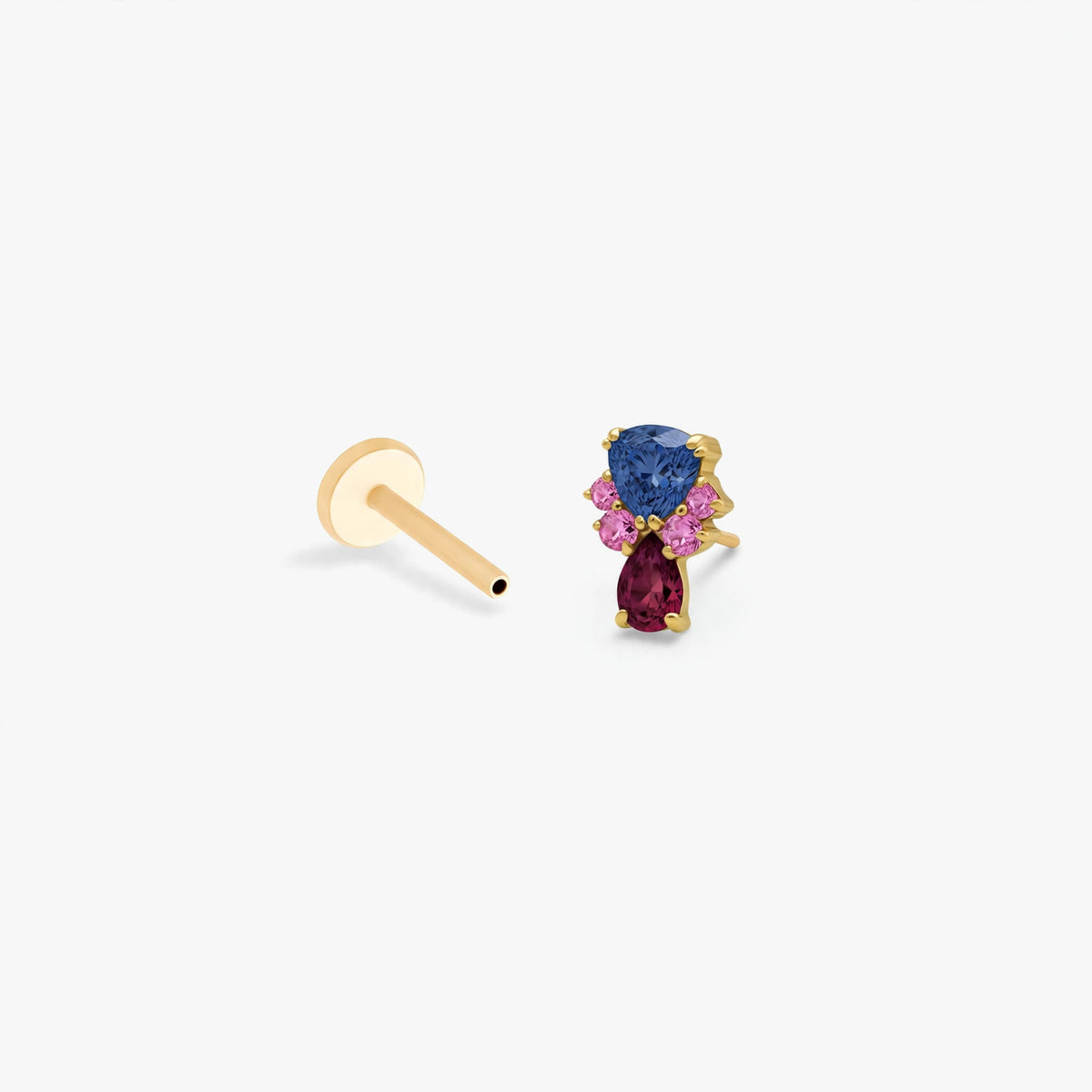 This image show the side view of the anodized triangle crown flatback separated from labret. the flatback has a blue cz stone on the top, a pear red cz stone on the bottom and four  pink cz circular stones on each side of the earring. 