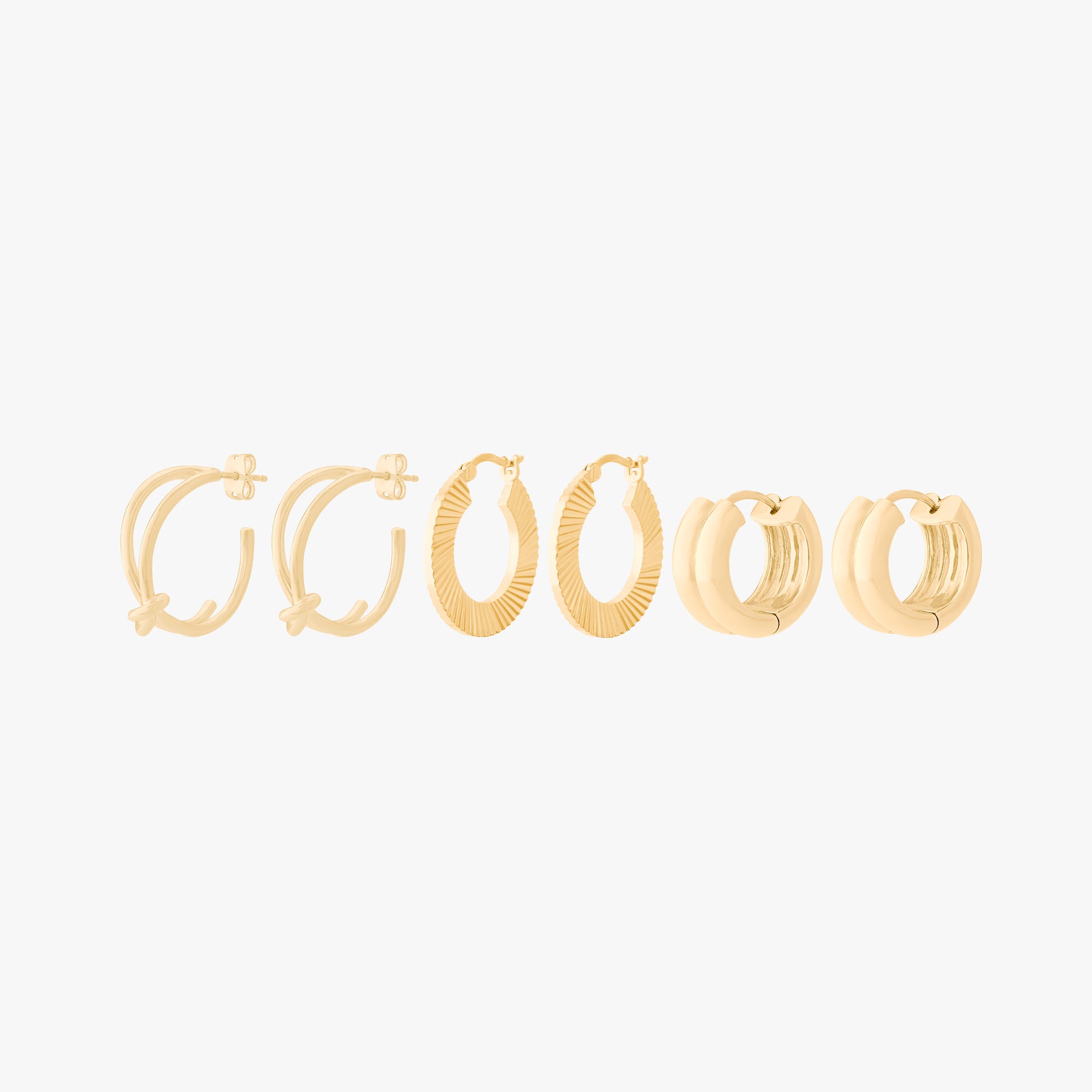 Ultimate Hoop Set featuring 3 pairs of gold hoops - the Knot Hoop, the Fluted Crescent, and the Chunky Ridge. - Main view