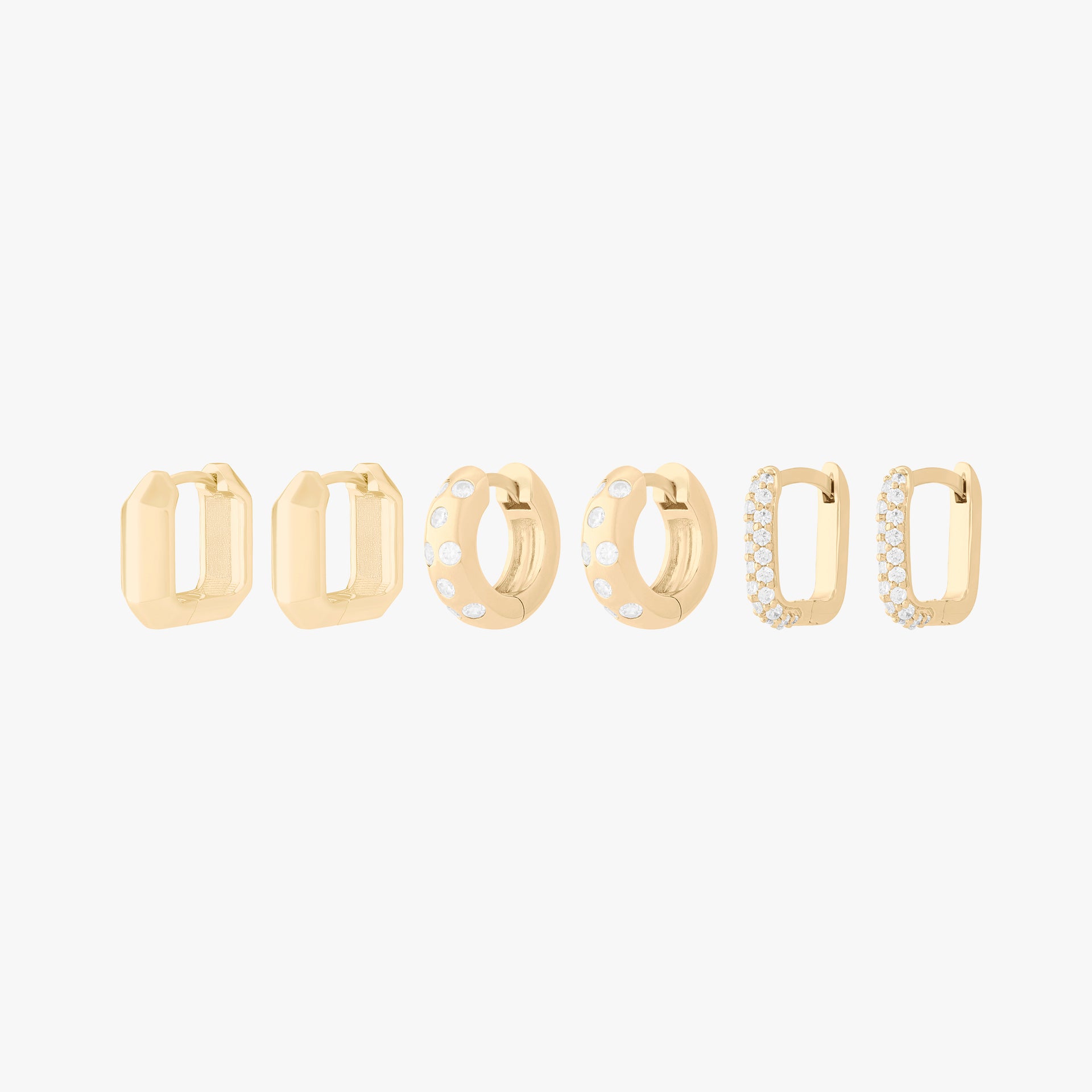 Ultimate Huggie Set featuring 3 pairs of gold huggies - the geometric, the chunky cz, and the pave square. - Main view