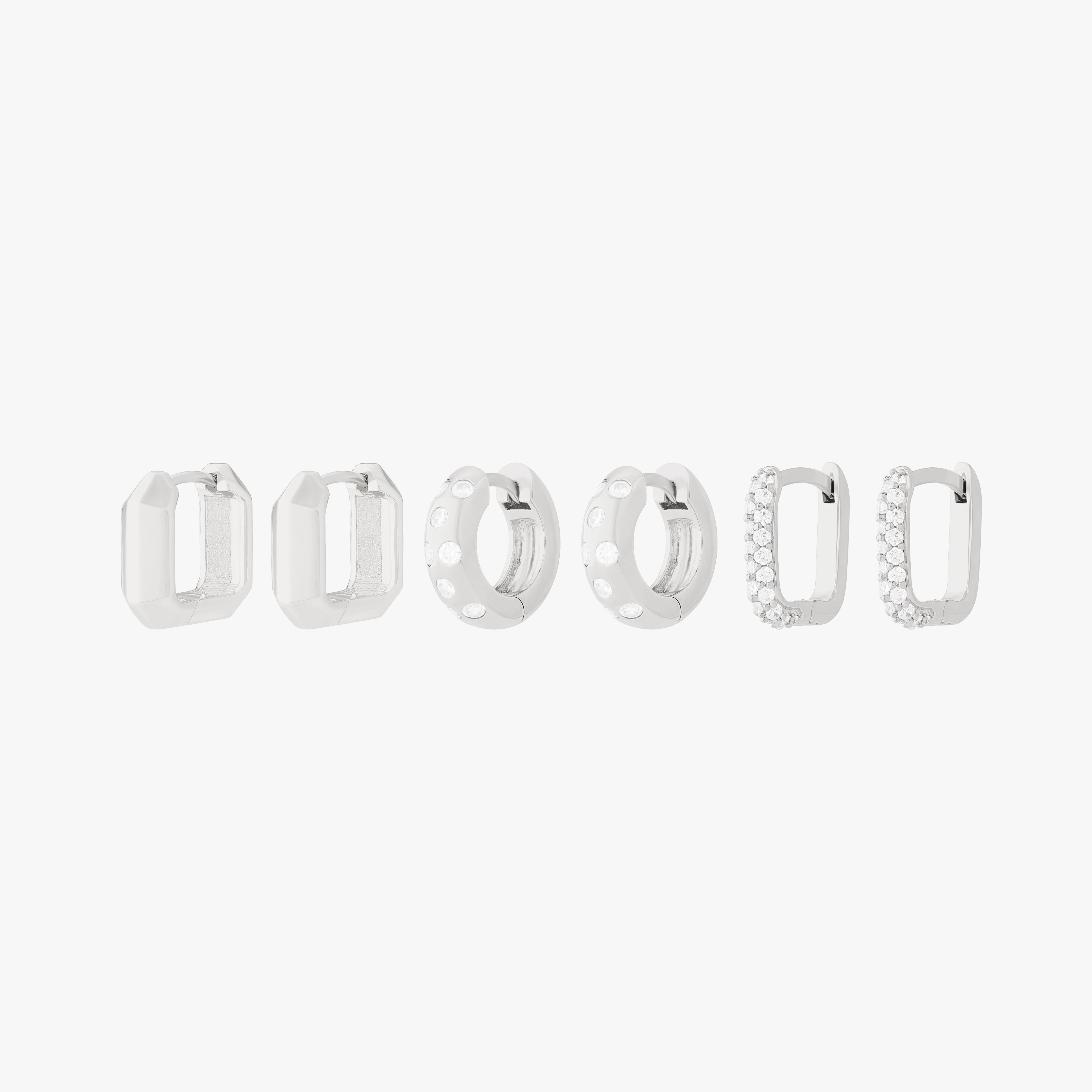 Ultimate Huggie Set featuring 3 pairs of silver huggies - the geometric, the chunky cz, and the pave square. - Main view