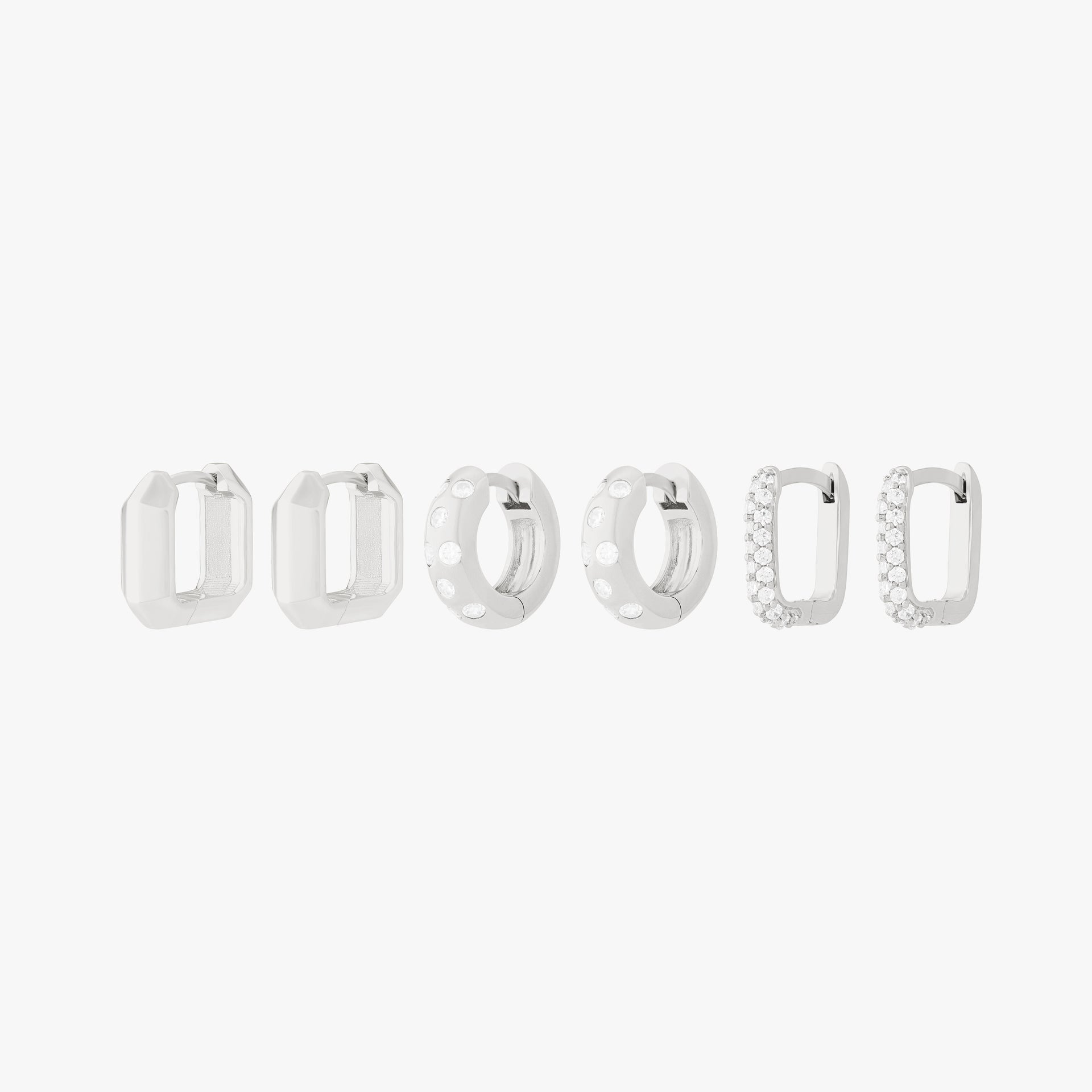 Ultimate Huggie Set featuring 3 pairs of silver huggies - the geometric, the chunky cz, and the pave square. - Main view