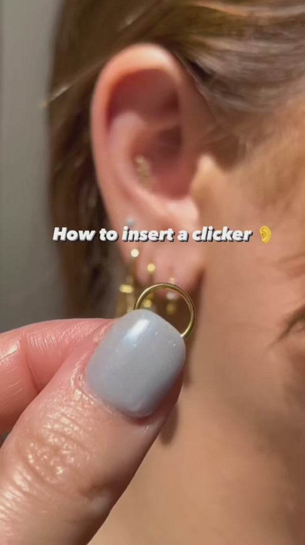 A video explaining how to insert a clicker earring into your ear. The video includes text subtitles and an audio voiceover explaining what is happening in the video.