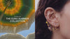 video featuring the new euro summer collection with an umbrella on the left and a variety of ears with gold euro themed earrings