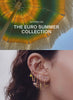video featuring the new euro summer collection with an umbrella on the left and a variety of ears with gold euro themed earrings