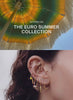 video featuring the new euro summer collection with an umbrella on the left and a variety of ears with gold euro themed earrings