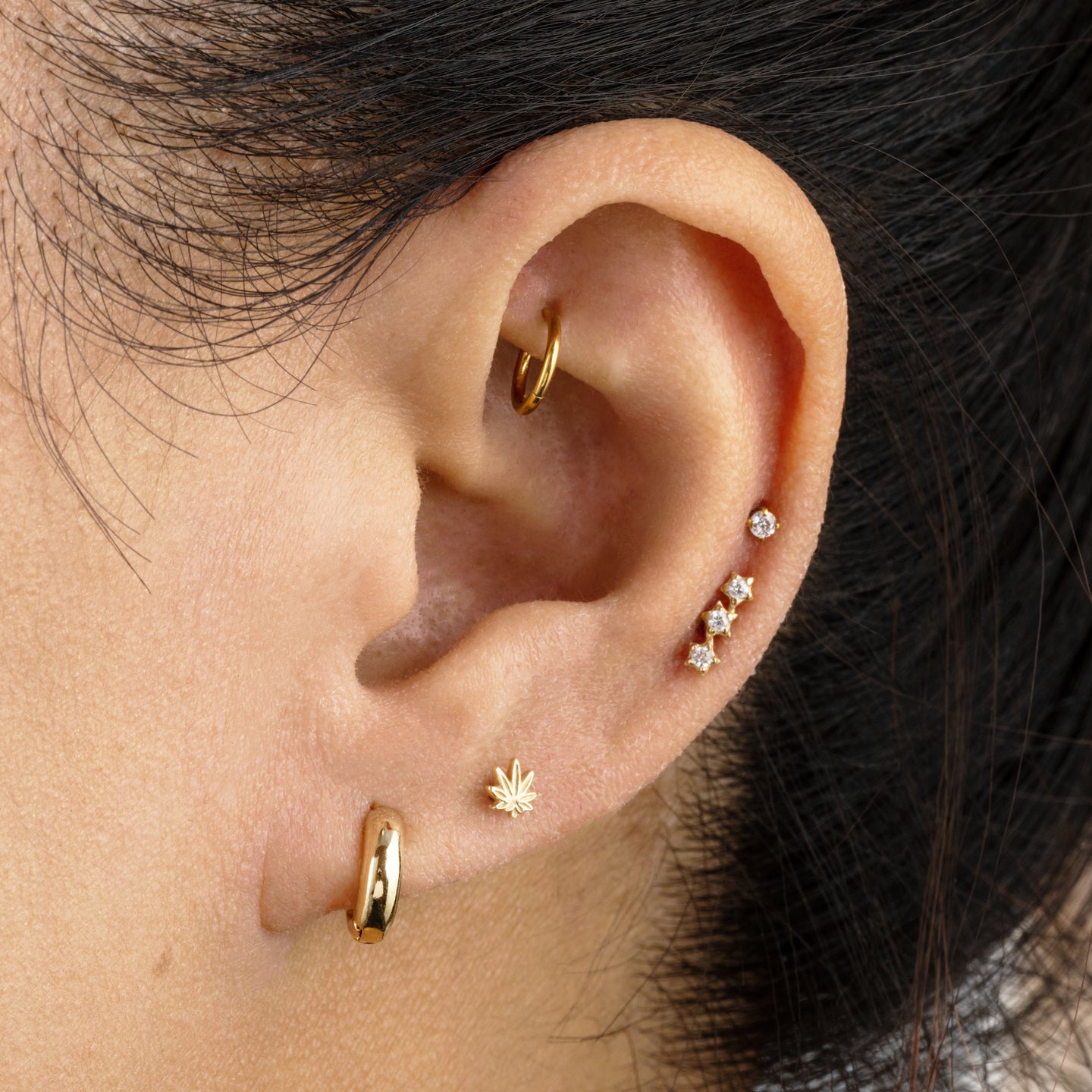 This is a 14k gold stud with 3 CZ's in a star shape color:null|14k gold/clear|gold/clear