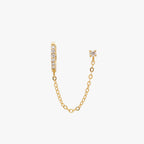 Chained gold huggie with cubic zirconia and gold stud with cubic zirconia. 
