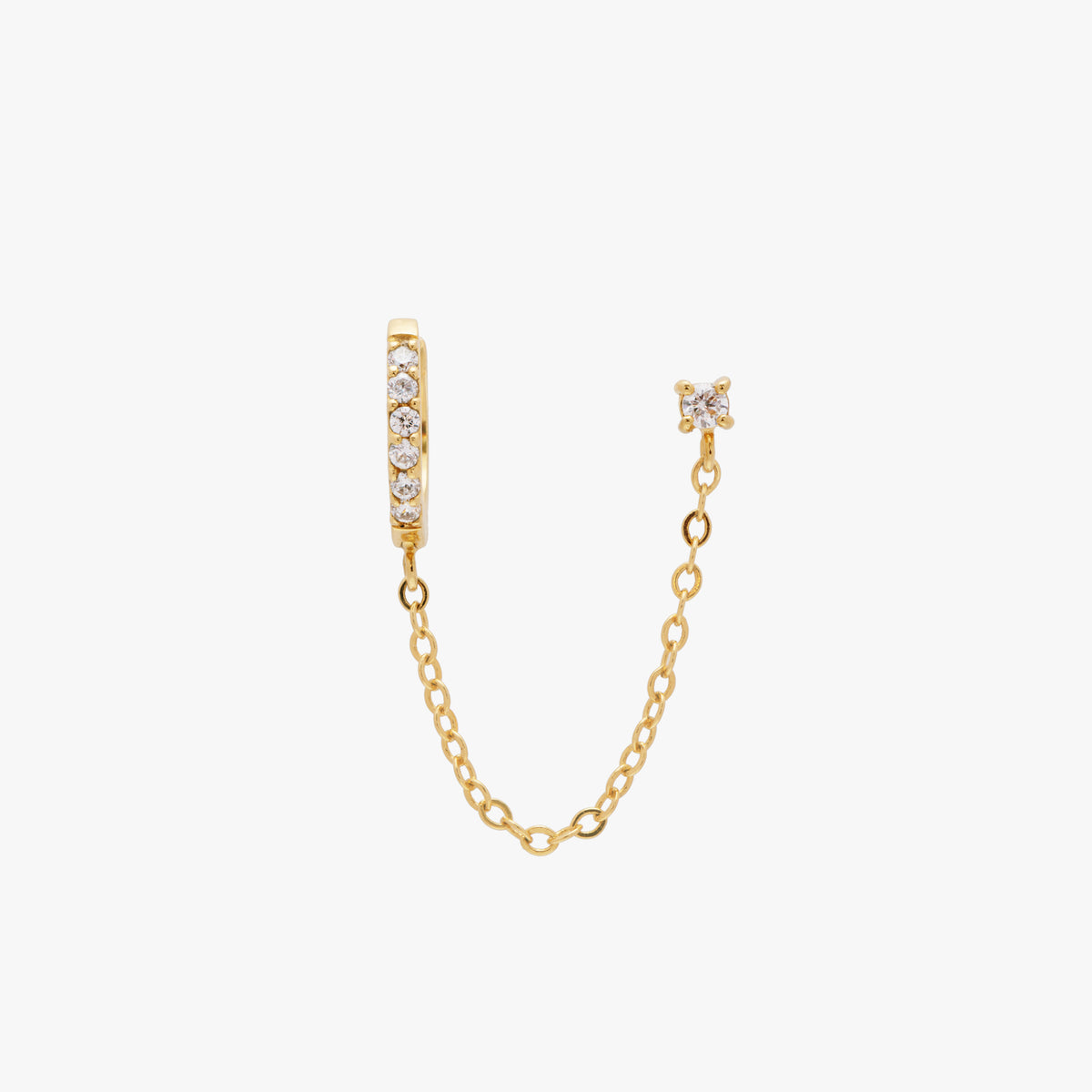 Chained gold huggie with cubic zirconia and gold stud with cubic zirconia. 