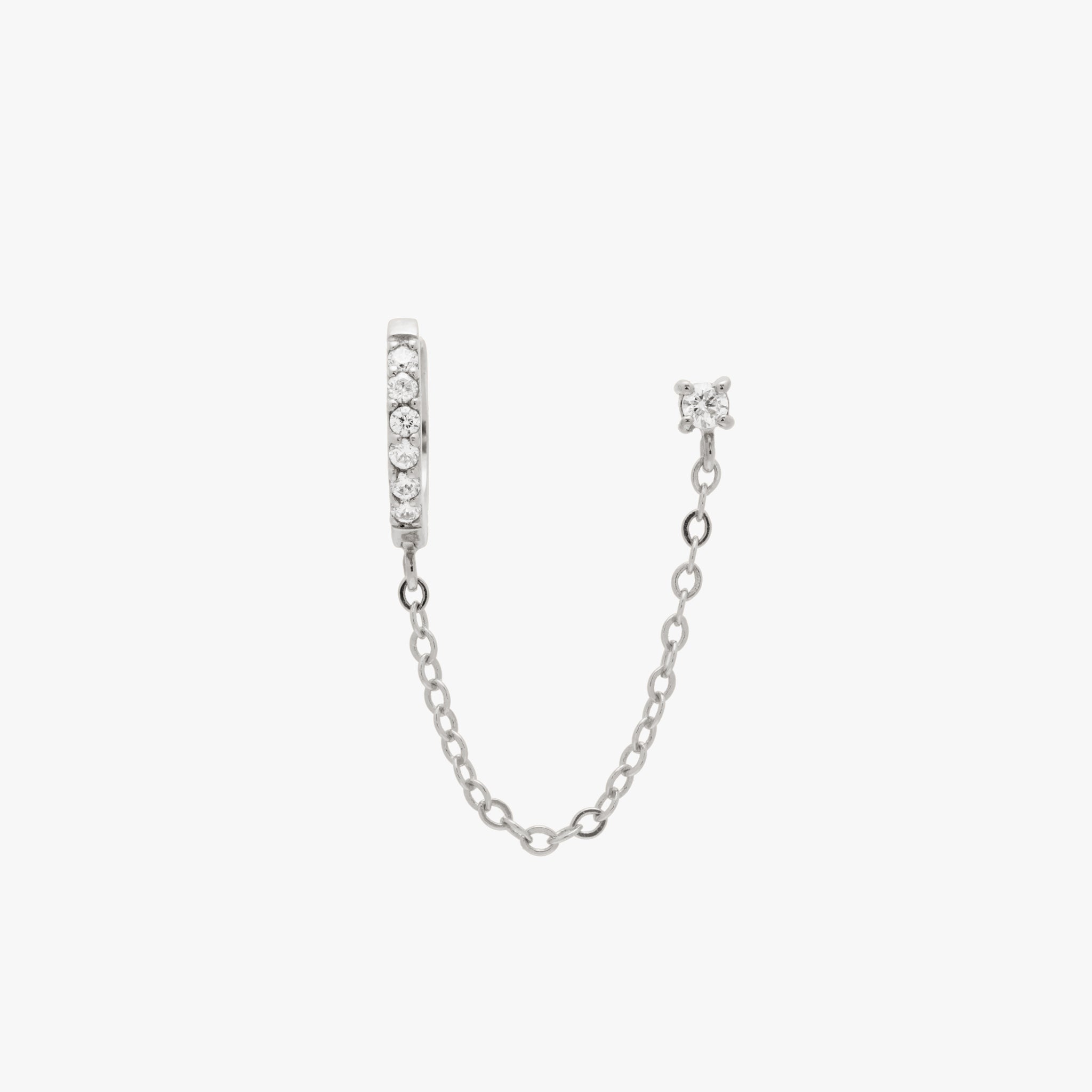Chained silver huggie with cubic zirconia and silver stud with cubic zirconia. color:silver/clear