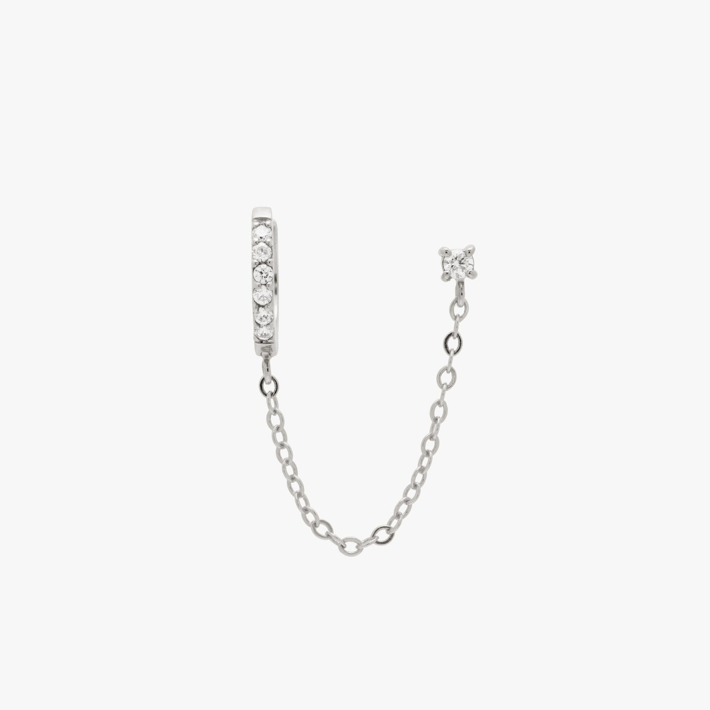 Chained silver huggie with cubic zirconia and silver stud with cubic zirconia. color:silver/clear