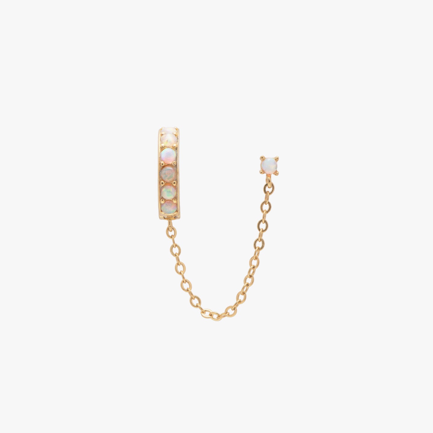 This is a small gold opal lined huggie connected with an opal stud by a chain color:null|gold/opal