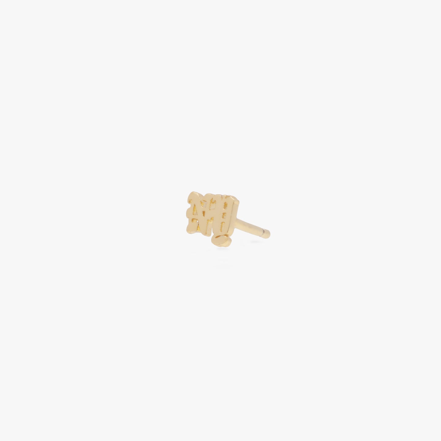 This is a small gold stud that says the 