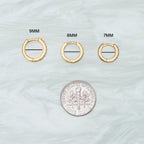 This is a small gold huggie with pavé detailing that measures 8mm [hover] color:null|gold/clear