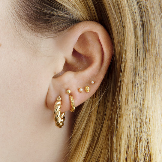 This is a small gold hoop with a twisted detail [hover] color:null|gold
