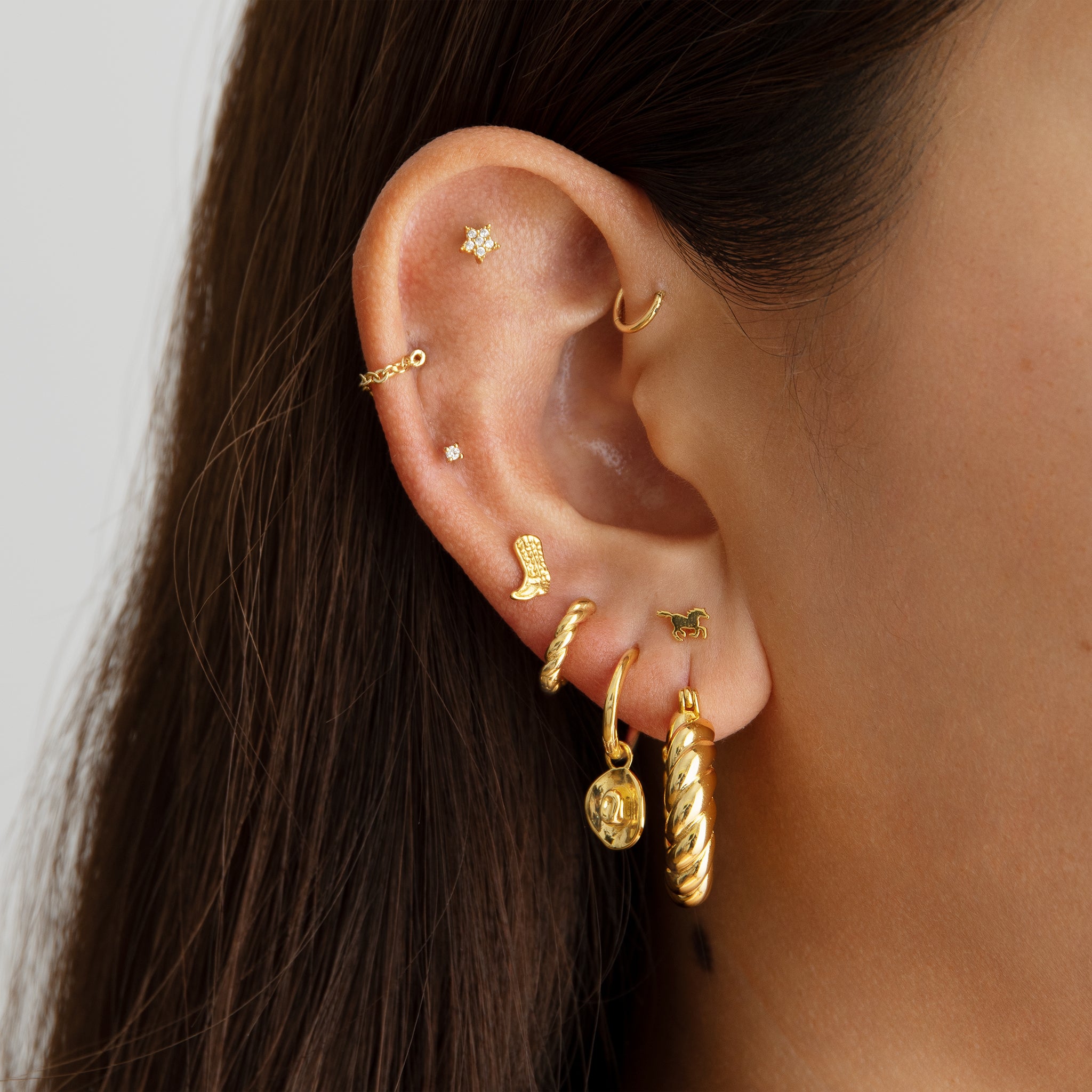 A medium sized gold hoop with french twist detailing [hover] color:null|gold