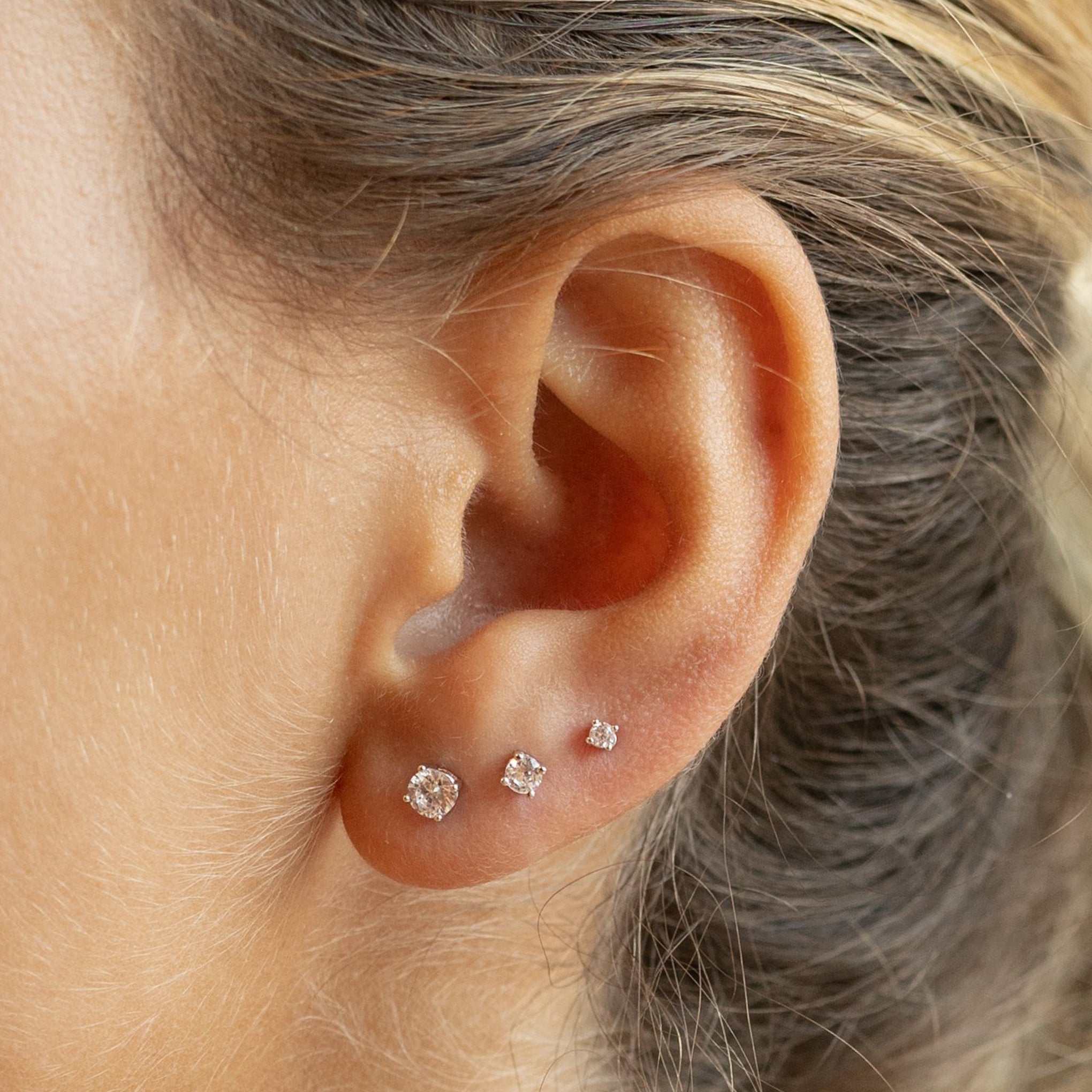 This is a set of silver studs that includes a pair of small cz studs, a pair of mini cz studs, and a pair of micro cz studs. [hover] color:null|silver/clear