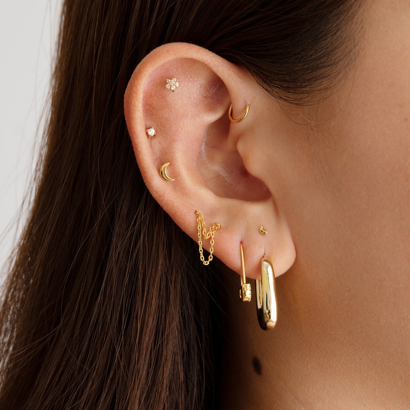A gold small moon shaped stud [hover] color:null|gold