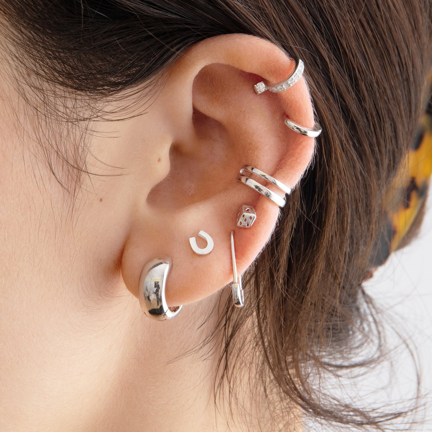 A silver safety pin shaped earring [hover] color:null|silver