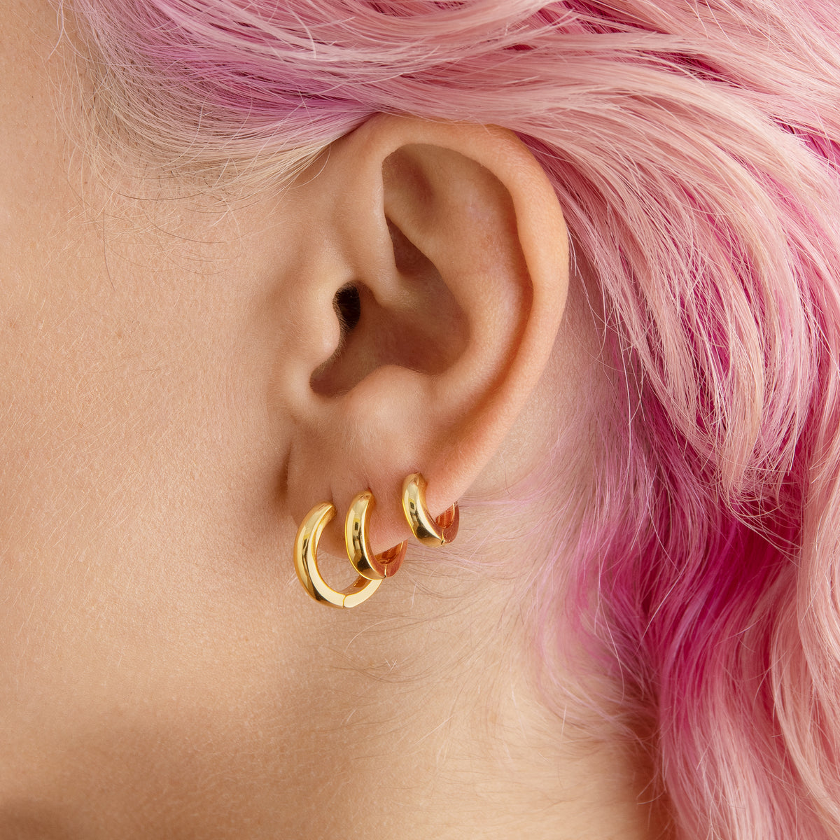 A set of chunky hoops containing a pair of micro gold chunky huggies, mini gold chunky huggies, and small gold chunky huggies [hover] color:null|gold