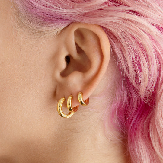 A set of chunky hoops containing a pair of micro gold chunky huggies, mini gold chunky huggies, and small gold chunky huggies [hover] color:null|gold