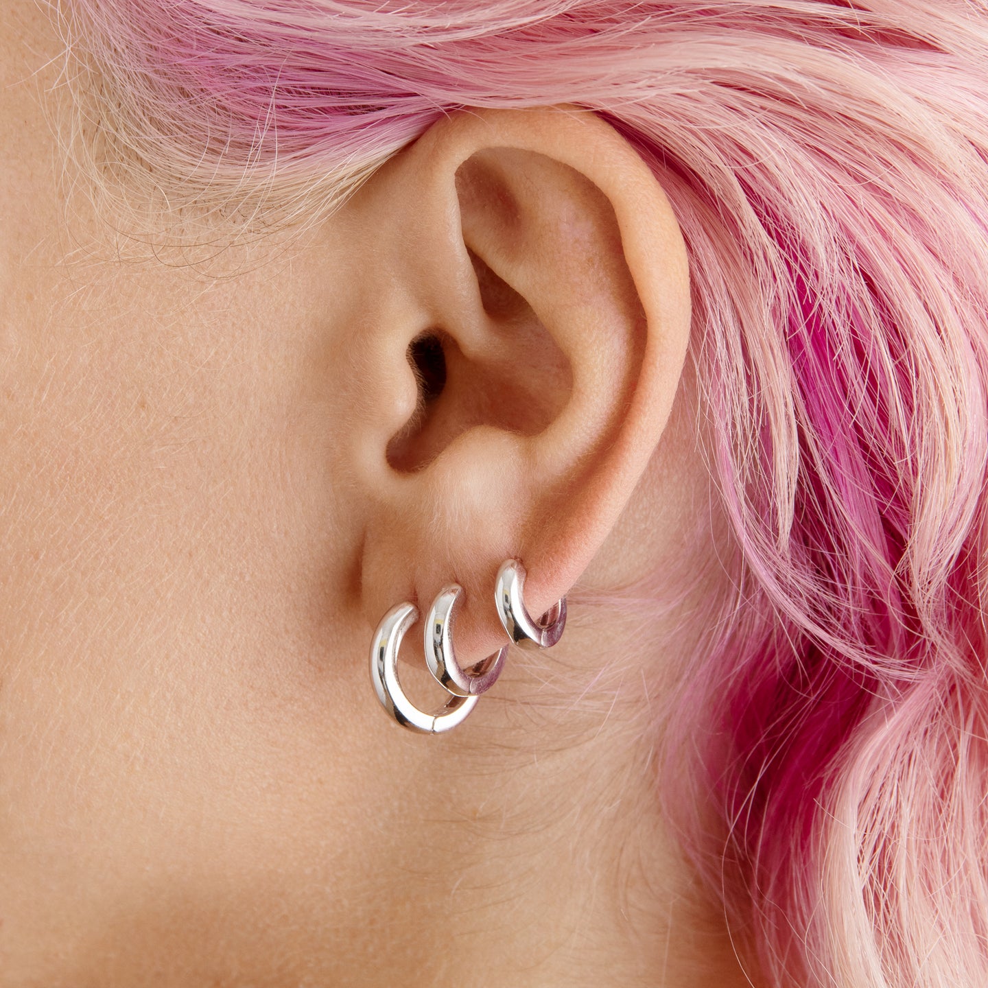 A set of Chunky Hoops that include a pair of micro silver chunky huggies, a pair of mini silver chunky huggies, and a pair of small silver chunky huggies [hover] color:null|silver