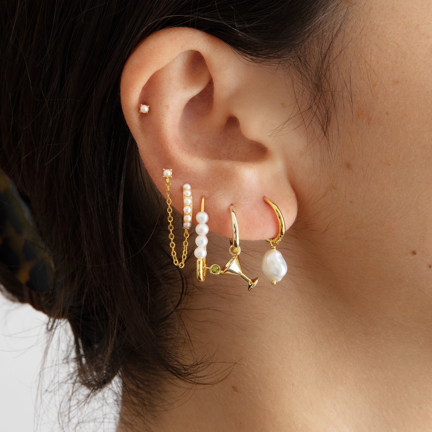 This is a small gold safety pin earring with pearl accents [hover] color:null|gold / gold|gold