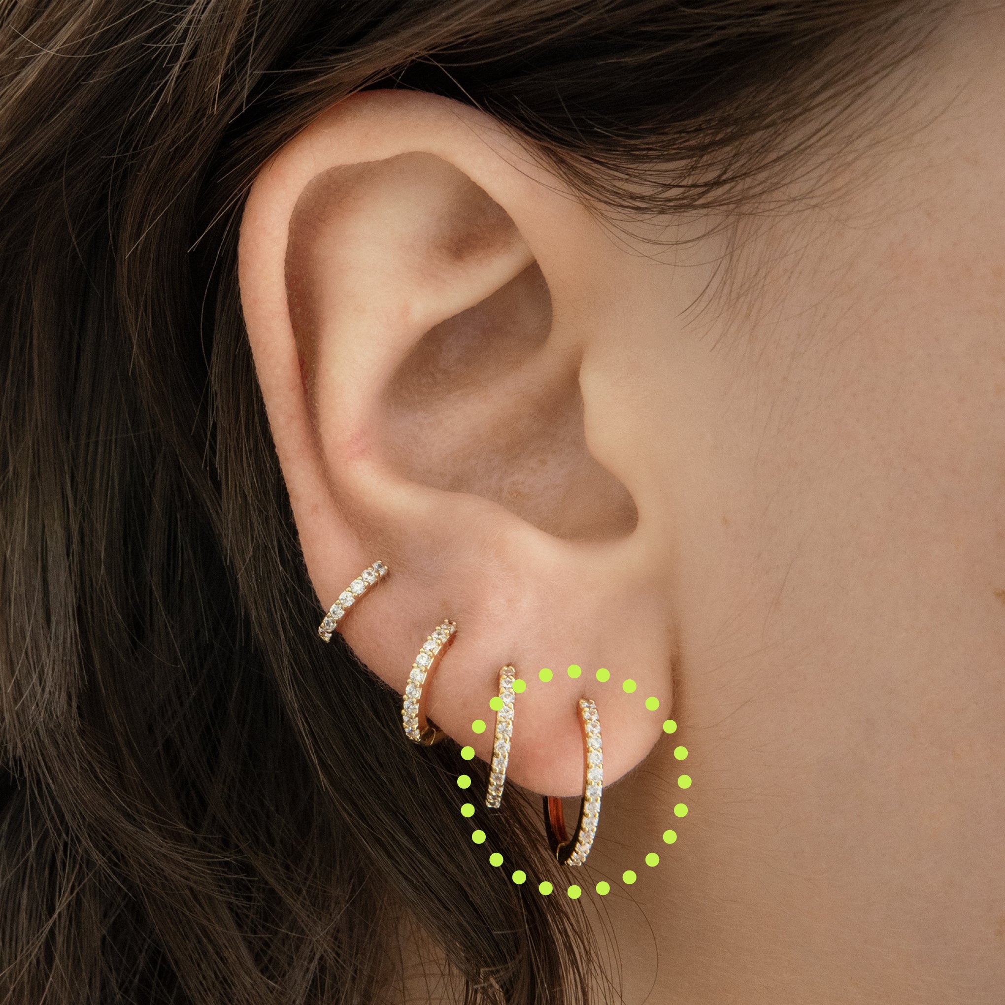 This is a small gold hoop measuring 12mm that features clear cz gems along the front [hover] color:null|gold/clear