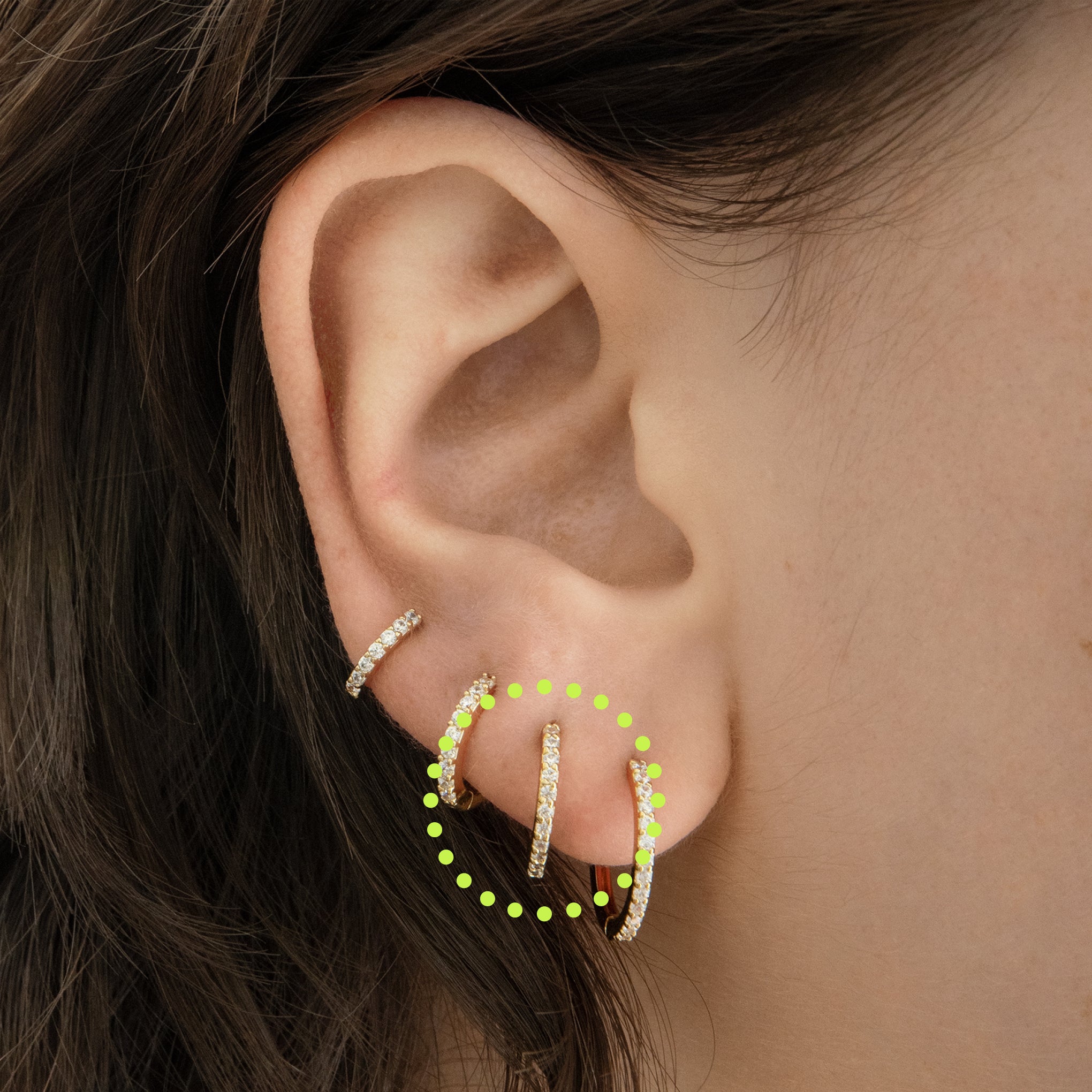 This is a small gold huggie measuring 13mm that features clear cz gems along the front [hover] color:null|gold/clear|silver/clear