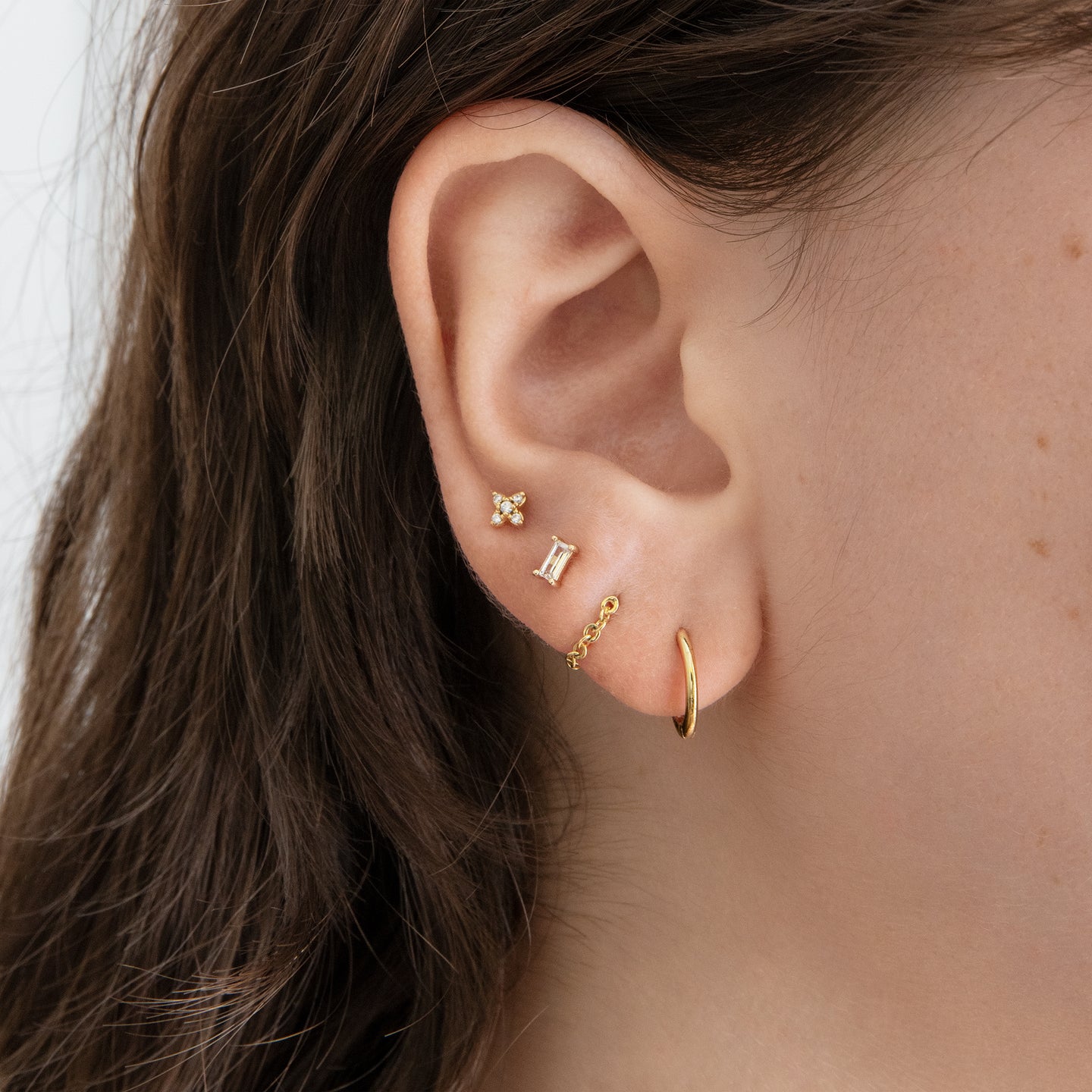 This is a small gold X stud with pavé detailing [hover] color:null|gold