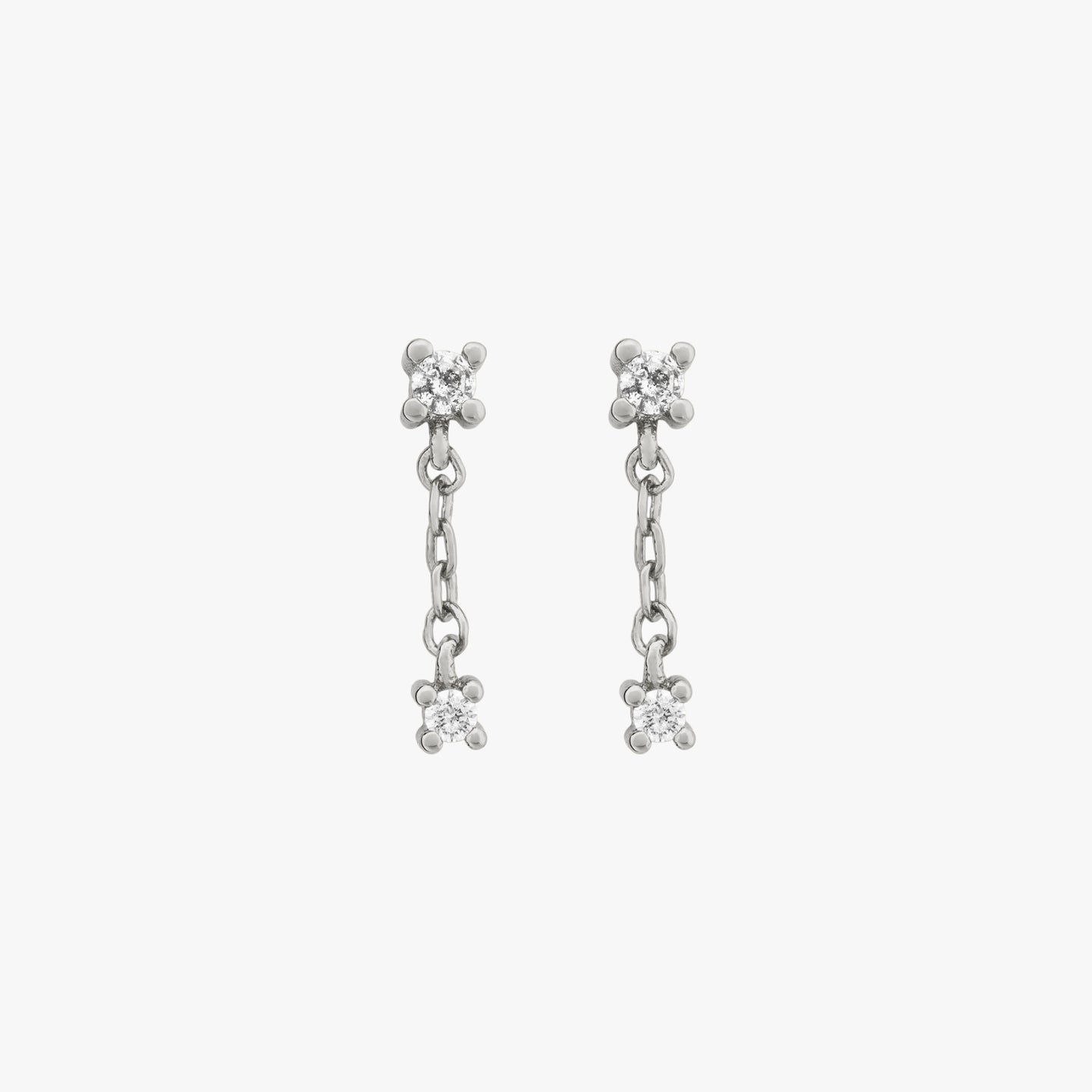 This is a small cz stud with a dangling cz connected by a silver chain [pair] color:null|silver/clear