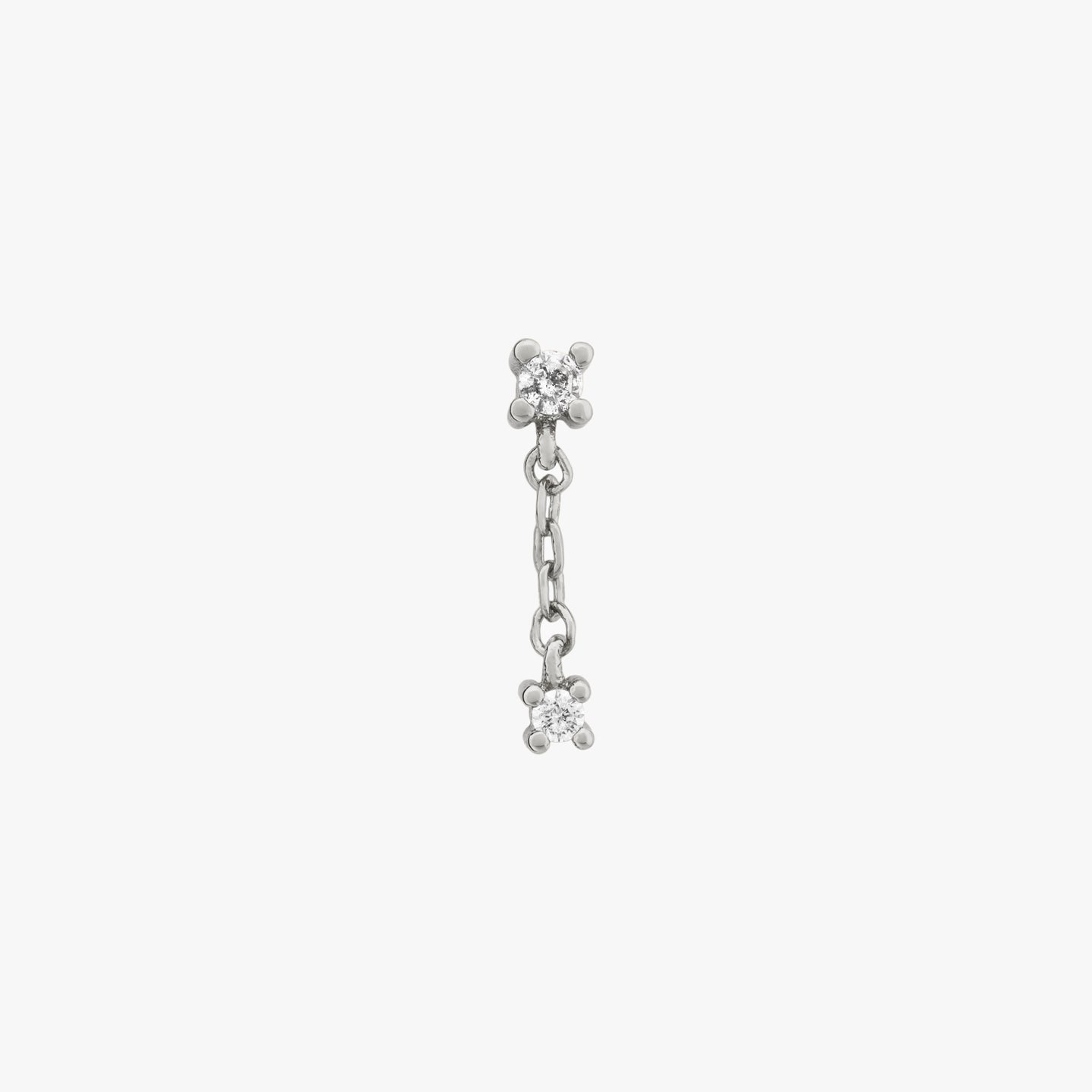 This is a pair of small cz studs with a dangling cz connected by a silver chain color:null|silver/clear