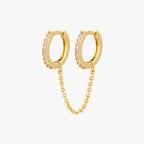 Two separate CZ front huggies attached by a gold chain. 