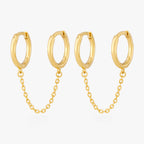 A pair of two separate hoop earrings connected by a chain. [pair] color:null|gold