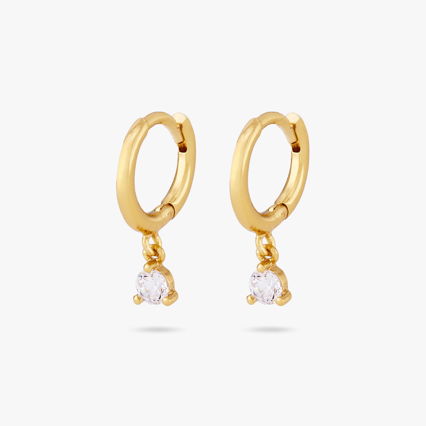 This is a pair of gold huggies with a cz stone dangling [pair] color:null|gold/clear