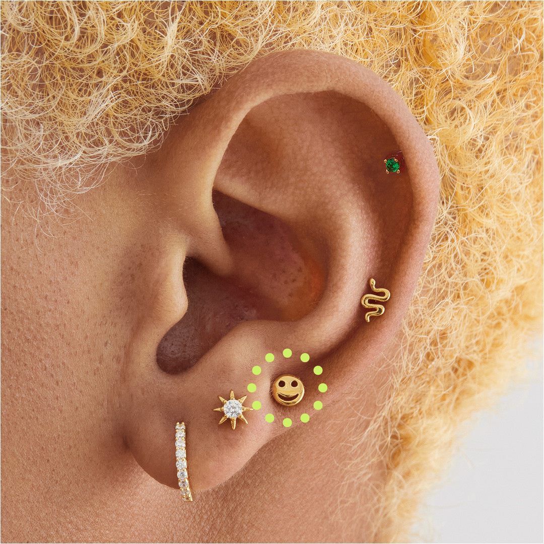 This is a small gold smiley face stud [hover] color:null|gold