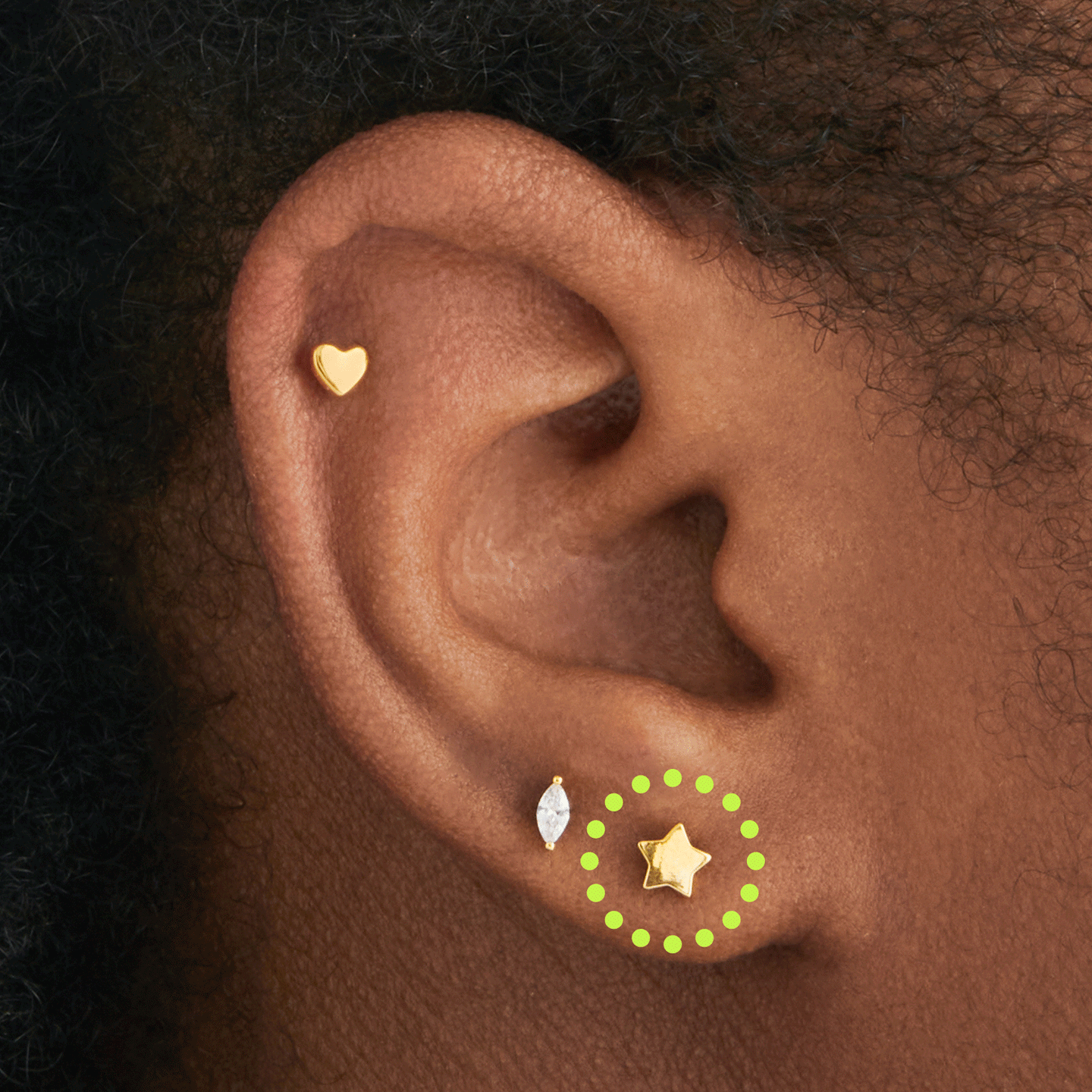 a gold labret with a star shaped disc with a moon shaped gold flatback top that works to be reversible on ear [hover] color:null|gold