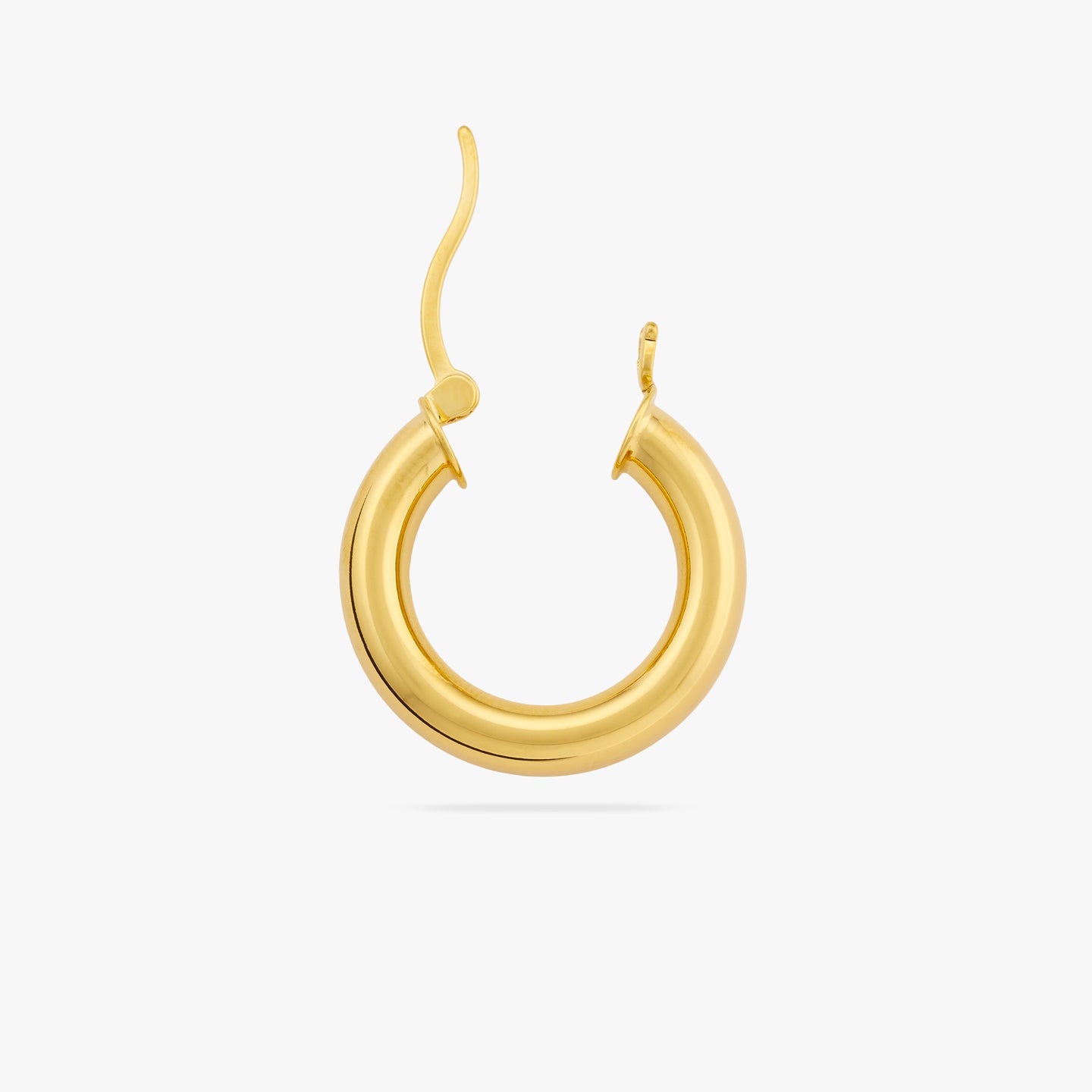 This is a chunky gold tube hoop with its clasp undone color:null|gold