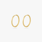 Pair of medium sized slim simple gold hoops. [pair] color:null|gold