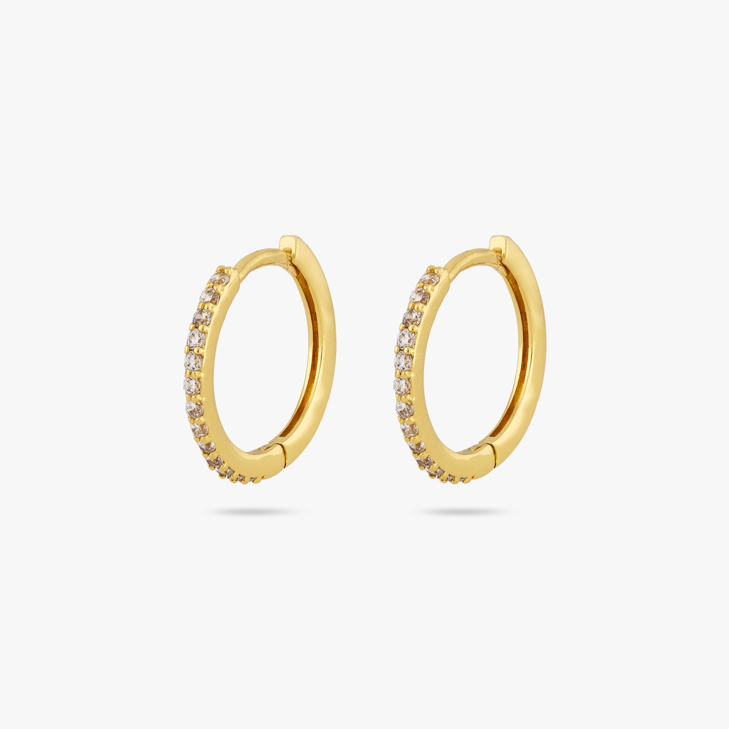 This is a pair of small gold hoops with clear cz gems along the front of them [pair] color:null|gold/clear