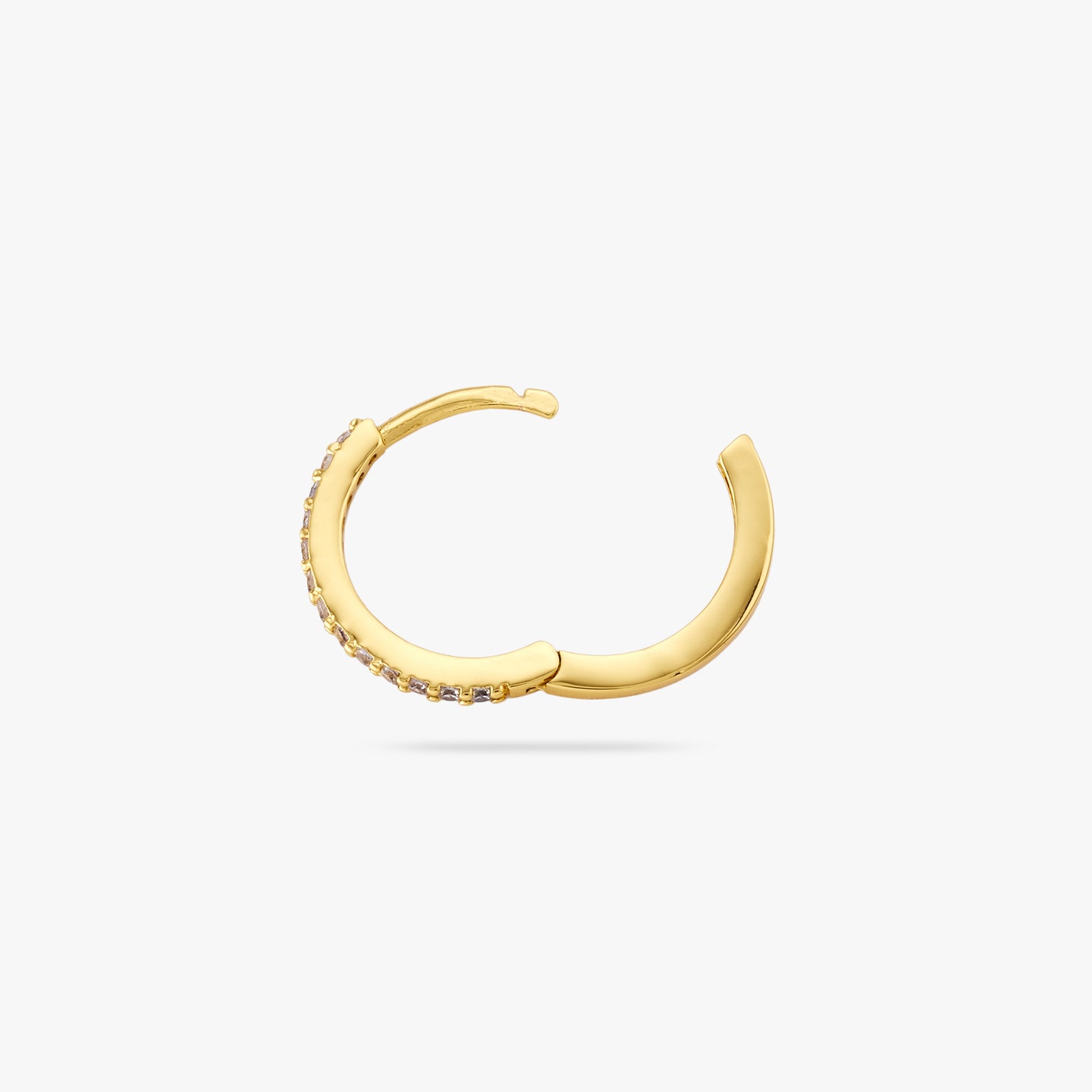 This is a small gold hoop with clear cz gems along the front and the clasp is undone color:null|gold/clear