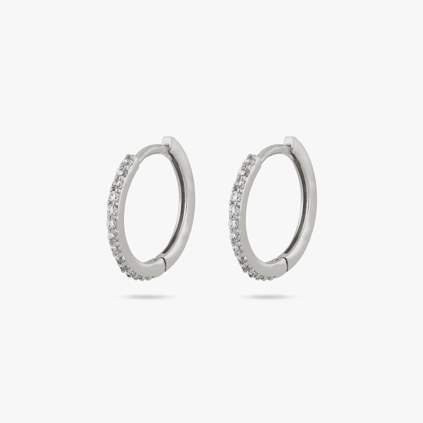 This is a pair of small silver hoops with clear cz gems along the front of them [pair] color:null|silver/clear