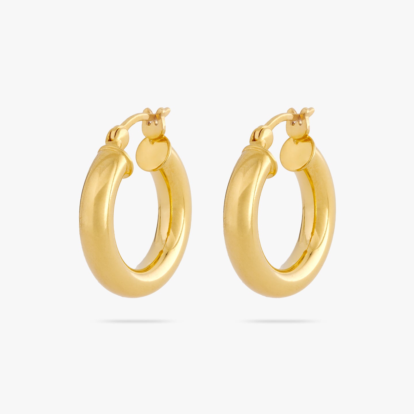 This is a pair of small gold chunky tube hoops [pair] color:null|gold