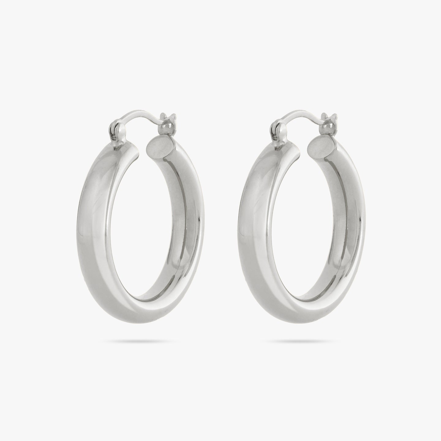 A pair of large, thick silver hoops. [pair] color:null|silver