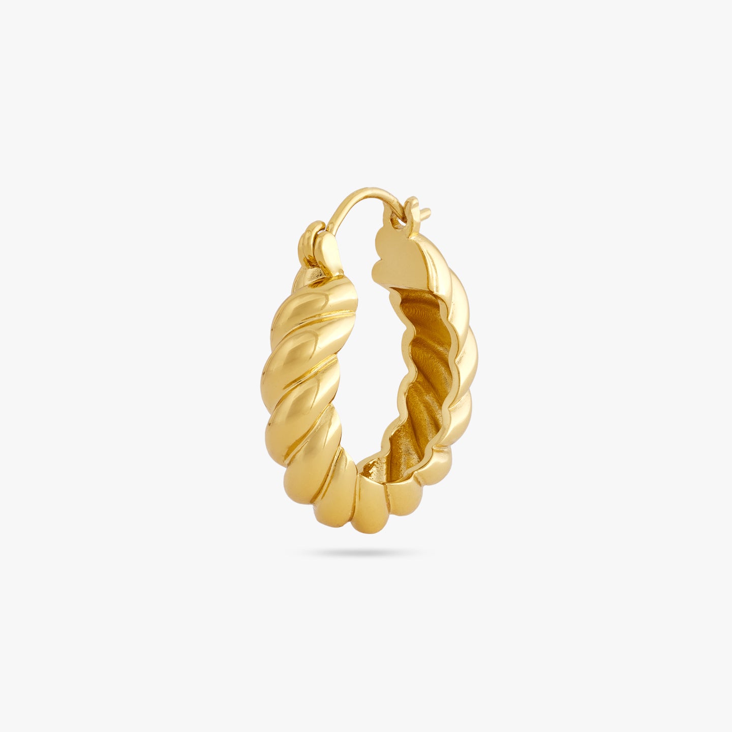 A medium sized gold hoop with french twist detailing color:null|gold