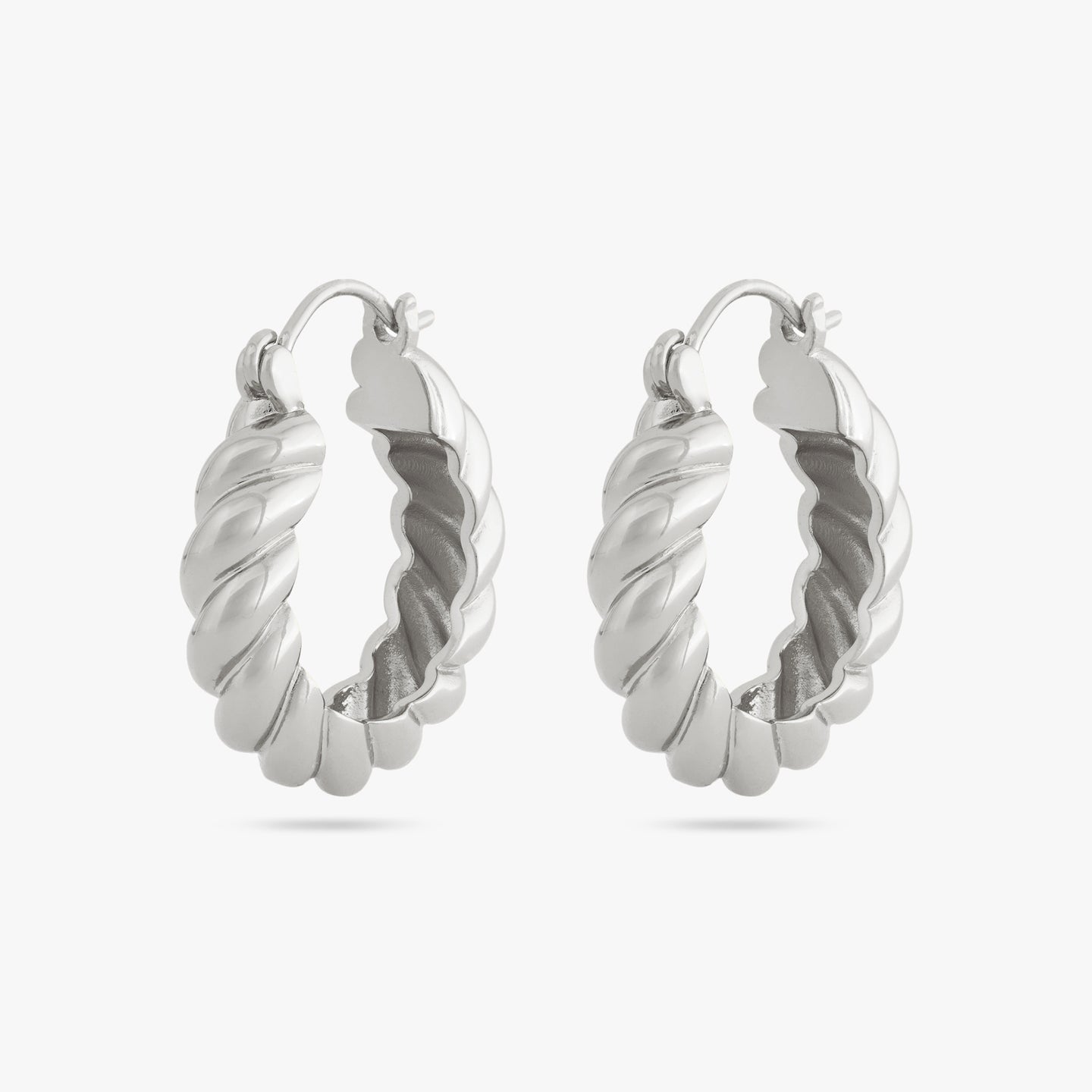 A pair of medium sized silver hoops with french twist detailing [pair] color:null|silver