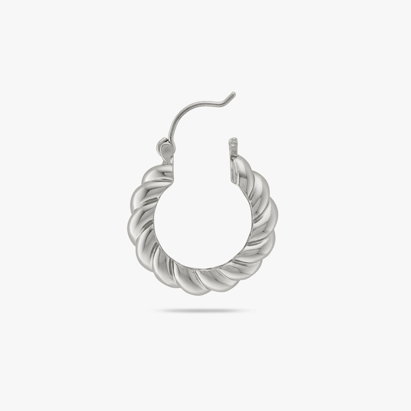 A medium sized silver hoop with french twist detailing and its clasp undone color:null|silver