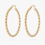 a pair of large gold slim twisted hoop earrings 