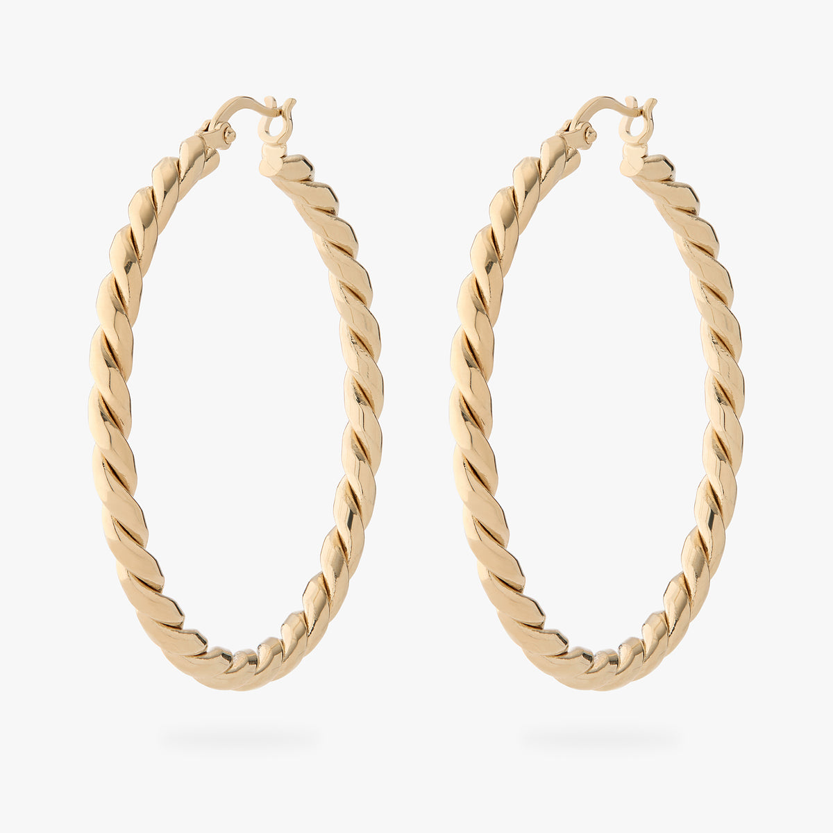a pair of large gold slim twisted hoop earrings 